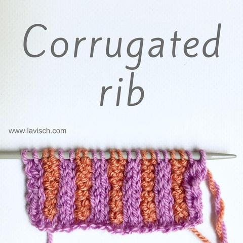 A swatch in lilac and salmon pink yarn on a gray knitting needle, showing 2x2 corrugated rib.