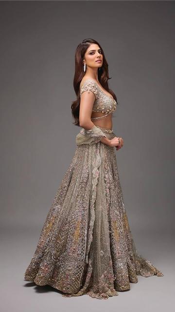 With a fairytale-inspired style, Malavika Mohanan captivates in her crystal ivory lehenga that’s all about elegance and sparkle. This dreamy lehenga combines classic design with crystal embellishments, making it the perfect outfit for someone looking for elegance with a touch of magic. Malavika’s flawless look highlights the lehenga’s intricate details, creating a mesmerizing aesthetic that speaks to traditional glamour.
