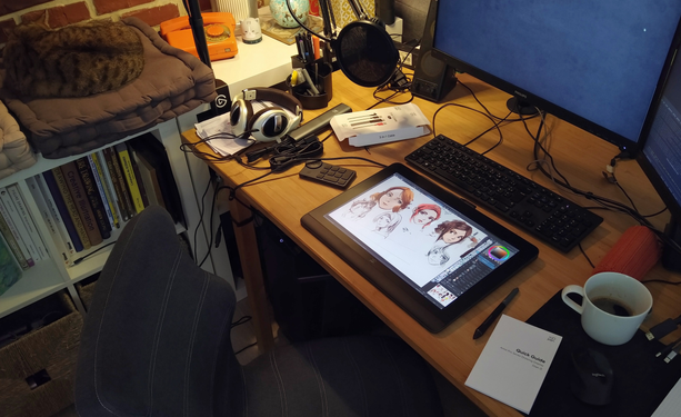 Desk with a tablet, keyboard, mouse, monitors, headphones. A work environment of an illustrator. 