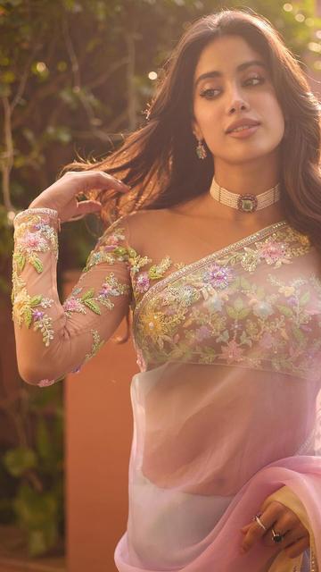 Janhvi Kapoor's latest style statement in a Manish Malhotra saree is the epitome of elegance. The soft pink ombre tones and delicate floral designs add a breathtaking touch that elevates Janhvi's look to the next level. A blend of traditional grace and modern allure, this saree shows Janhvi’s flair for unforgettable fashion moments. Join us as we explore every detail of Janhvi’s mesmerizing outfit and celebrate this perfect harmony of beauty and style!