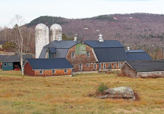 A weathered group of barns on an overcast November afternoon.