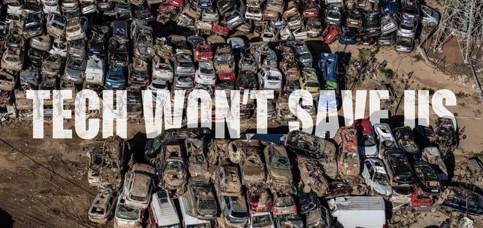Aerial view of hundreds of mud-caked cars stacked up in a post-flood car graveyard near Valencia, with the words “Tech won’t save us” superimposed.
