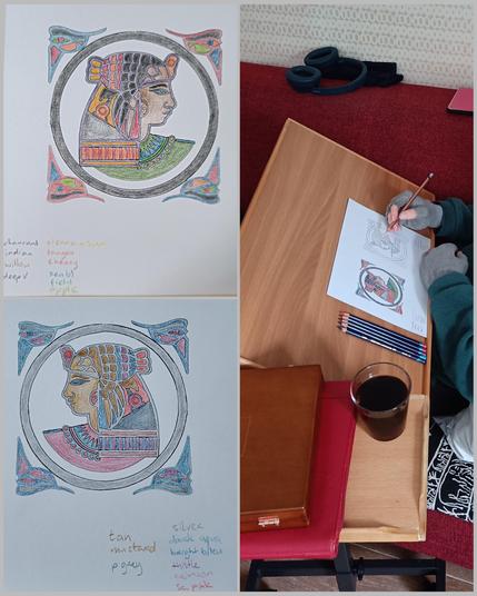 Compilation of 3 photos. Left: two finished colouring for adults pictures of Egyptian figure. Above an expressive colourful one. Below more subdued scheme. 
Right: my colouring table with my hand holding pencil. Work in progress on the Egyptian subdued colour scheme 