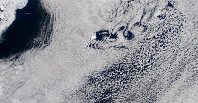 Satellite image of Jan Mayen with clouds forming von Kármán vortex street.