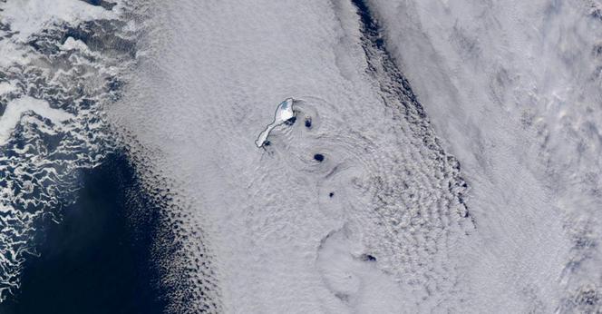 Satellite image of Jan Mayen with clouds forming von Kármán vortex street.