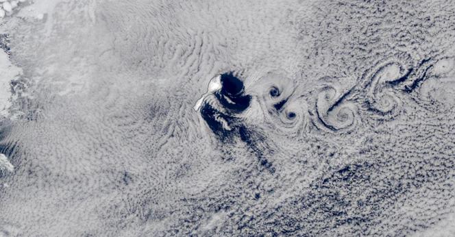 Satellite image of Jan Mayen with clouds forming von Kármán vortex street.