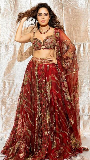 Nushrratt Bharuccha’s radiant red lehenga blends intricate embroidery with bold color to create an unforgettable look. This outfit is perfect for bridal or festive occasions, offering a mix of sophistication and style. Explore her fashion choices to redefine your wardrobe!