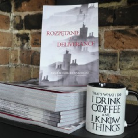 Photo of a drinking mug beside copies of 'Deliverance', by Anna Blasiak and Lisa Kallo