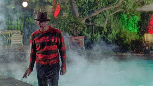 Freddy Krueger from A Nightmare on Elm Street 2: Freddy's Revenge. He is facing the camera, no one else in the shot. A steaming pool is behind him.