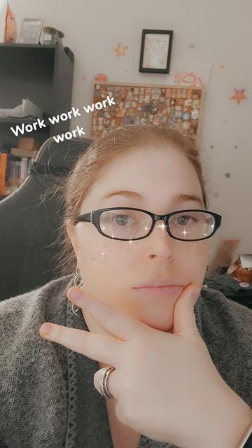 Selfies picture of me with a dumb snapchat filter over my face. Thumb on my chin and two fingers out in some sort of faux peace sign. I got sparkle freckles from the filter too. Text above me reads "work work work work"
