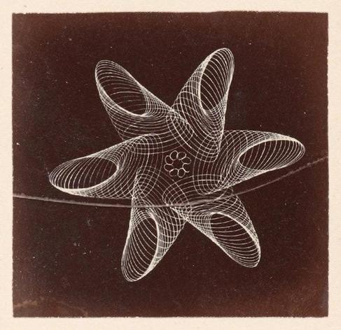 Ornamental turning patterns from the book shown as faint white lines on a black background