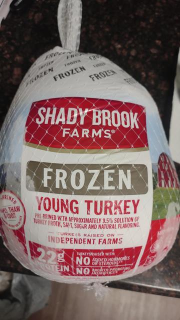 A red and white label that says  Shadybrook Farms frozen turkey.