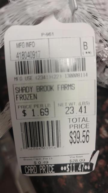 A price tag for a 23.41lb frozen turkey showing the regular price of $39.56 and at the bottom in white on a black background the same price of $11.47.