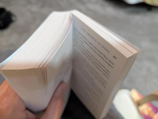 picture showing the top of my book. God emperor of dune and the place I am at. we are on page 409 which appears to be about a little over 3/4 of the way through the book. this is my reading position. you can see my bedroom floor pile of running clothes. still still there in the corner. I really don't want this book to end and then I don't want the next two books to end. it is such a marvelous universe.