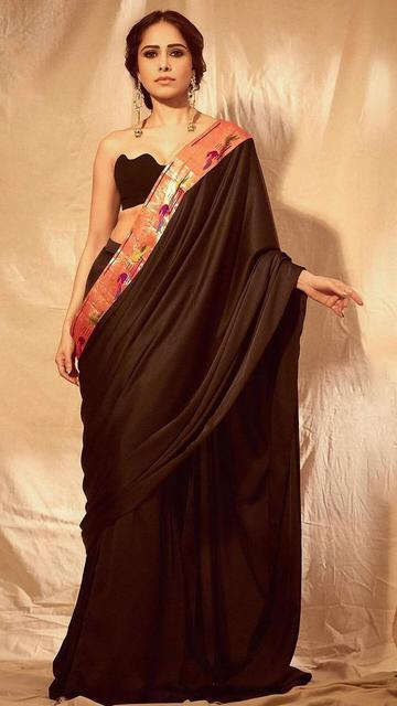Nushrratt Bharuccha’s black saree is taking the internet by storm! From its timeless design to her chic styling, this outfit is a fashion lesson in elegance and grace. Don’t miss out on recreating this style.