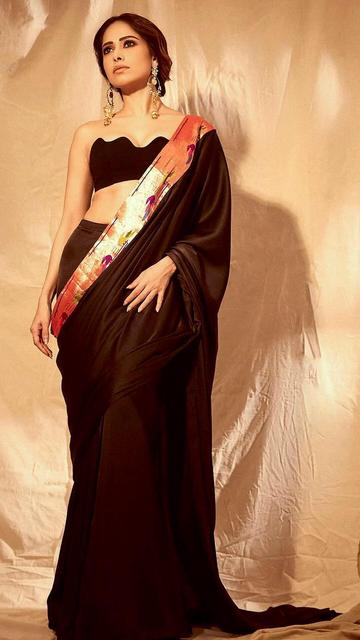 When it comes to ethnic glam, Nushrratt Bharuccha’s black saree look is a masterpiece. She pairs tradition with modernity, showcasing a flawless outfit that suits any occasion. Fashion inspiration guaranteed!