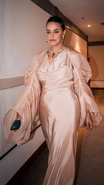 Neha Dhupia brings her A-game to fashion with this stunning satin and jewel combination. The luxurious satin fabric drapes her silhouette flawlessly, and her accessories add a perfect hint of sophistication. This look is a must-see for anyone seeking style inspiration.