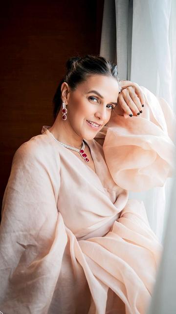 A satin masterpiece paired with exquisite jewels: Neha Dhupia's latest fashion outing is a lesson in elegance. The flowing satin fabric accentuates her every move, while her jewelry adds a sparkle that lights up the look. Dive into her classy yet contemporary style.