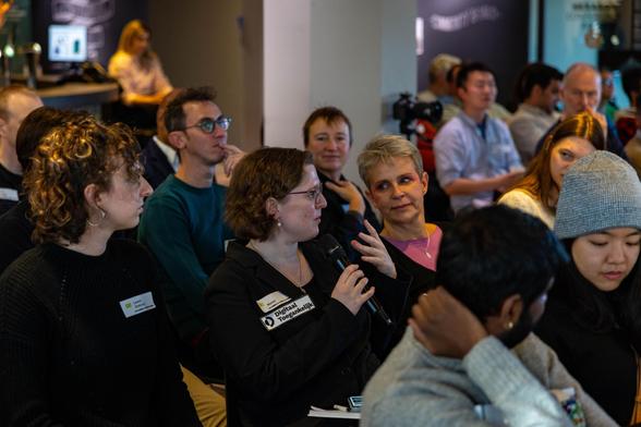 Woman asking a question to the presenter.