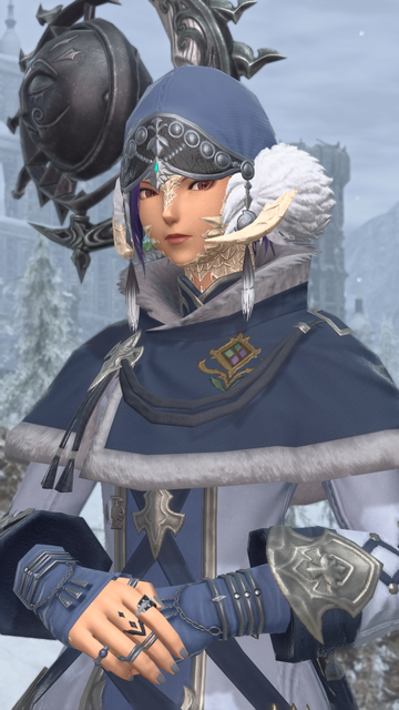 Portrait shot of Berin Rinrin, a female raen Au Ra in a dark blue winter outfit, her hands clasped in front of her. She is looking at the viewer with a cold expression.