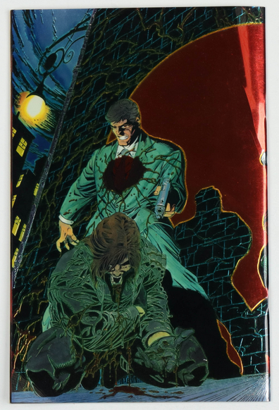 the back of the wraparound cover, a man on his knees bleeding in an alley, a man with a blood soaked suit pointing a gun at him