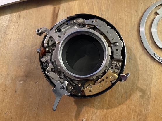 A Moskva 5 shutter at rest. Notice the small black component at the bottom of the frame, between the shutter release lever and the brass slow speed train? That's the catch lever.