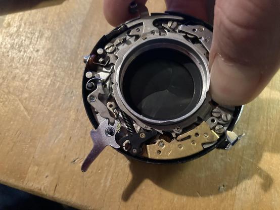 Here is the shutter when it's cocked. Notice the black catch lever sits into a notch on the mechanism - it's supposed to hold it in place until the shutter release pushes it out of the way. As you can see here, it's a very loose fit. Do not like.
