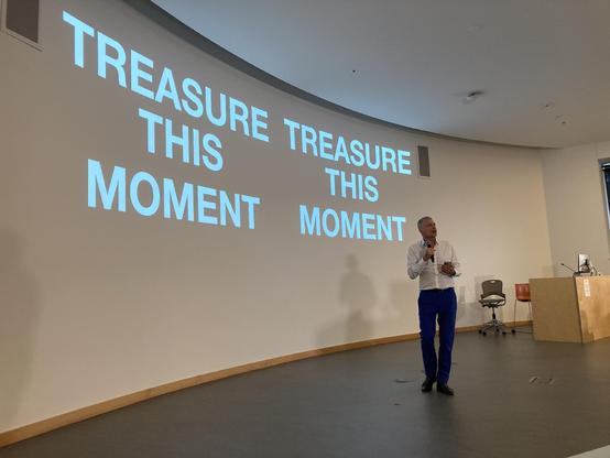 Mark pesce in front of a slide reading TREASURE THIS MOMENT 