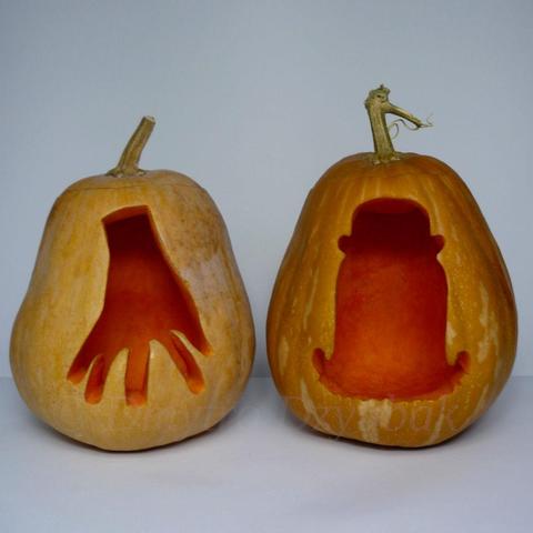 Thing T. Thing and Cousin Itt from The Addams Family are depicted on two carved pumpkins.