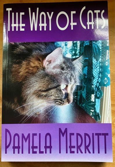Book cover, with a purple background and white letters, The Way of Cats Pamela Merritt, and a Maine Coon tabby at a window with green lace curtains.