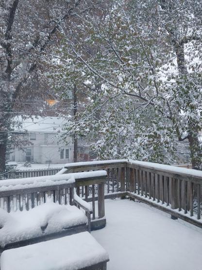 Snow covering a deck in a city neighborhood
