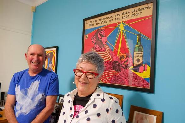 
Poster text: 

Q: If the unemployed are “dole bludgers” 
     What the fuck are the idle rich ? 

Photo:
Nick Southall and Sharon Pusell with an original Michael Callaghan poster commissioned by Steel City Pictures and printed at Queensland Film and Drama Centre, Griffith University, 1979. 

Photograph ABC Illawarra: Sarah Moss

