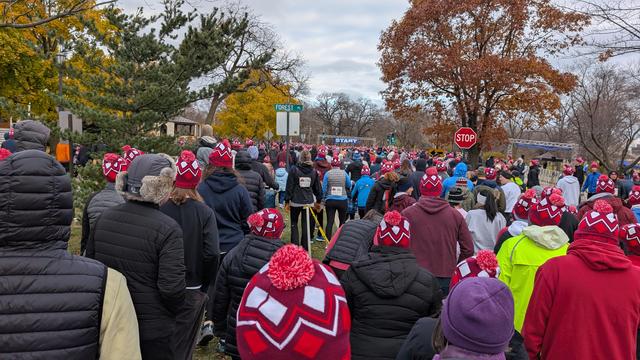 Race start: People bundled for a cold weather race in Evanston, Illinois, USA, with the start line visible in the distance.