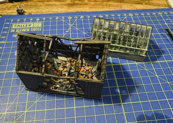 Model buildings on a blue cutting mat