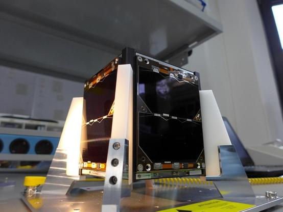 Close-up of the JY1sat satellite with solar panels visible on a black frame