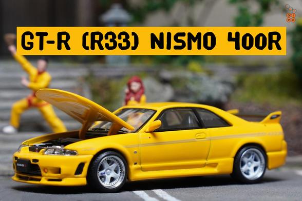 A left side of Nissan Skyline GT-R (R33) Nismo 400R Yellow by Pop Race in 1:64 scale with 1:64 figures on AREA 164
