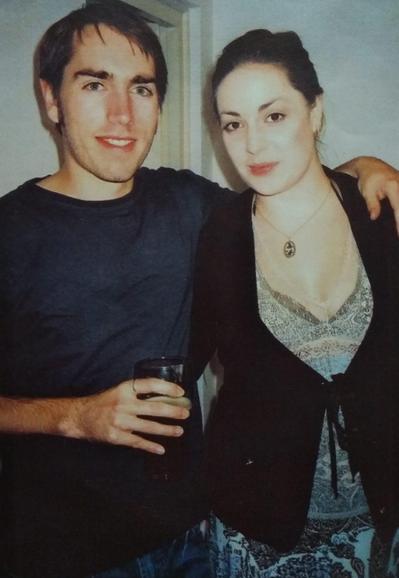 Dude and chick standing next to each other indoors.