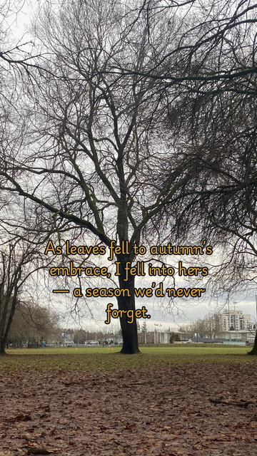 A serene autumn landscape with a bare tree in a park. The ground is covered in fallen leaves, and the sky is overcast, adding to the nostalgic atmosphere. Text overlay reads, "As leaves fell to autumn’s embrace, I fell into hers — a season we’d never forget," capturing the essence of romance and the beauty of fall.