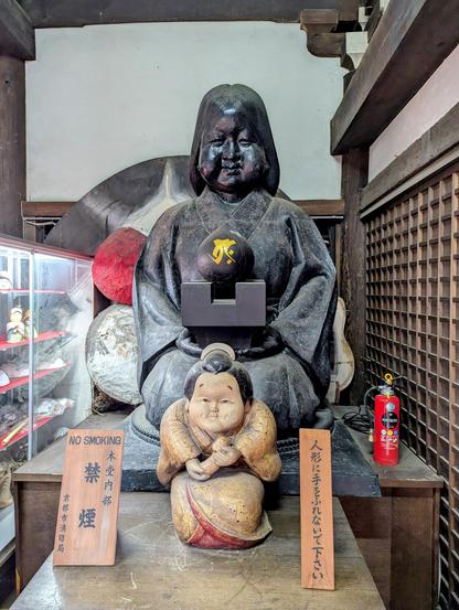 Images of Okame inside the main hall of Daihoon-ji. Now a folk figure, Okame was a real woman. The wife of the temple's head carpenter, she helped save construction of the main hall when her husband's calculations proved incorrect. Her reward? She killed herself to prevent anyone from knowing what had happened (the story got out anyway).