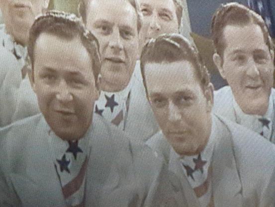 Young men chorus in patriotic ties in HOLIDAY INN. 