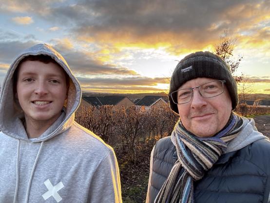 Picture of a young man (20) and an older man (54) walking 