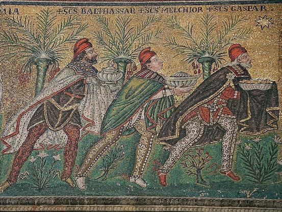 The Three Magi, Byzantine mosaic, c. 565, Basilica of Sant’ Apollinare Nuovo, Ravenna, Italy, restored during the 19th century. As here, Byzantine art usually depicts the Magi in Persian clothing, which includes breeches, capes, and Phrygian caps. Source: Wikimedia Commonsꜛ (license: CC BY-SA 2.5).