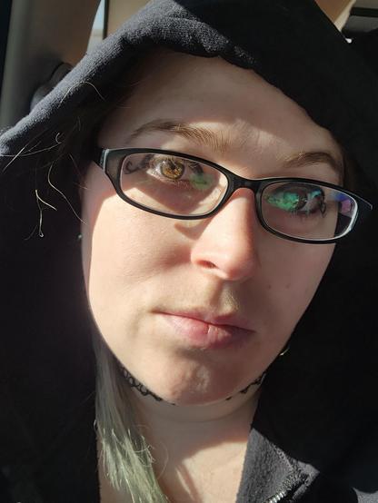 Picture of my face. I'm sitting in a car and have my hood up