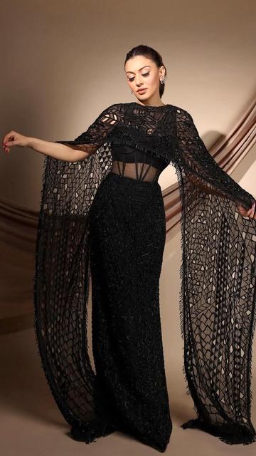 Hansika Motwani’s black gown and cape ensemble is a lesson in bold yet refined fashion choices. The gown’s flawless fit, paired with the cape’s dramatic flair, showcases her as a true style icon.