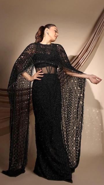 Taking glamour to the next level, Hansika Motwani stuns in a sleek black gown and cape. The look radiates sophistication and boldness, setting new fashion standards.