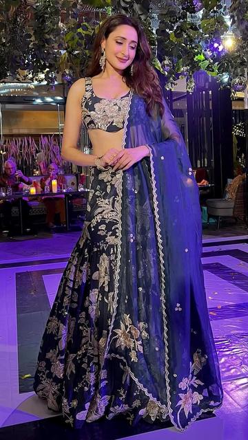 Elegance and allure meet in Pragya Jaiswal’s black fish-cut lehenga. Perfectly styled for a wedding event, this outfit highlights her refined taste and graceful persona.