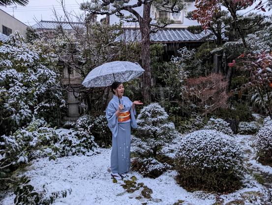 Nao-san enjoys some unexpected snow in the teahouse garden.