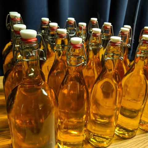 A square cropped photo of the wine as viewed from a corner of the arrangement. The wine is very clear.