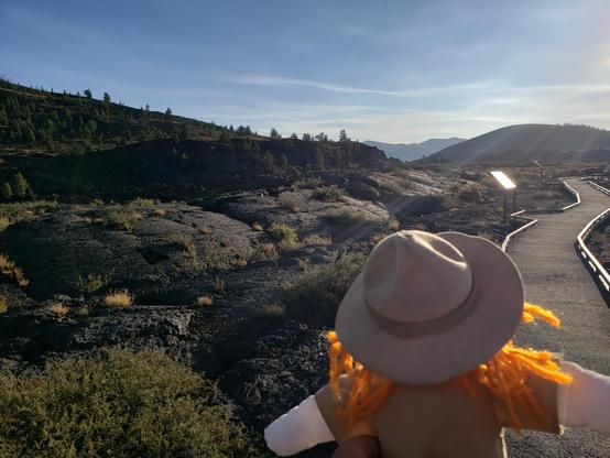 Ranger Sarah hikes through the Lava Field. As the lava cools, tiny magnetic crystals align themselves in the direction of the earth's current magnetic field. Scientist can use this information to date the lava fields.
— at Craters of the Moon NPS.
