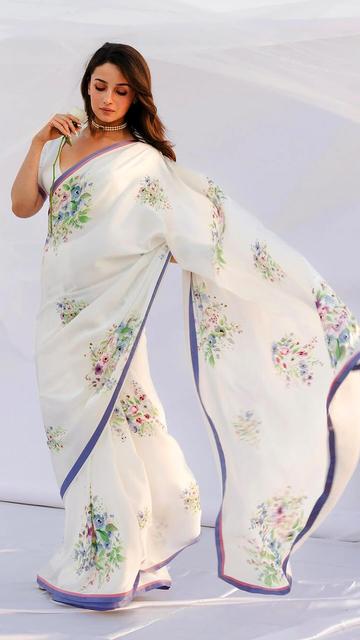 At the Raj Kapoor Awards, Alia Bhatt made a grand fashion statement in a Sabyasachi white floral saree. The delicate floral embroidery and soft drapes highlighted her graceful demeanor, while her simple accessories and glowing makeup made the look flawless. A perfect ode to timeless Indian fashion.